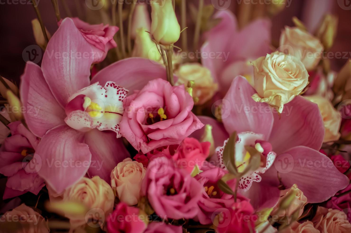 Bouquet with orchids and roses on a beautiful background photo