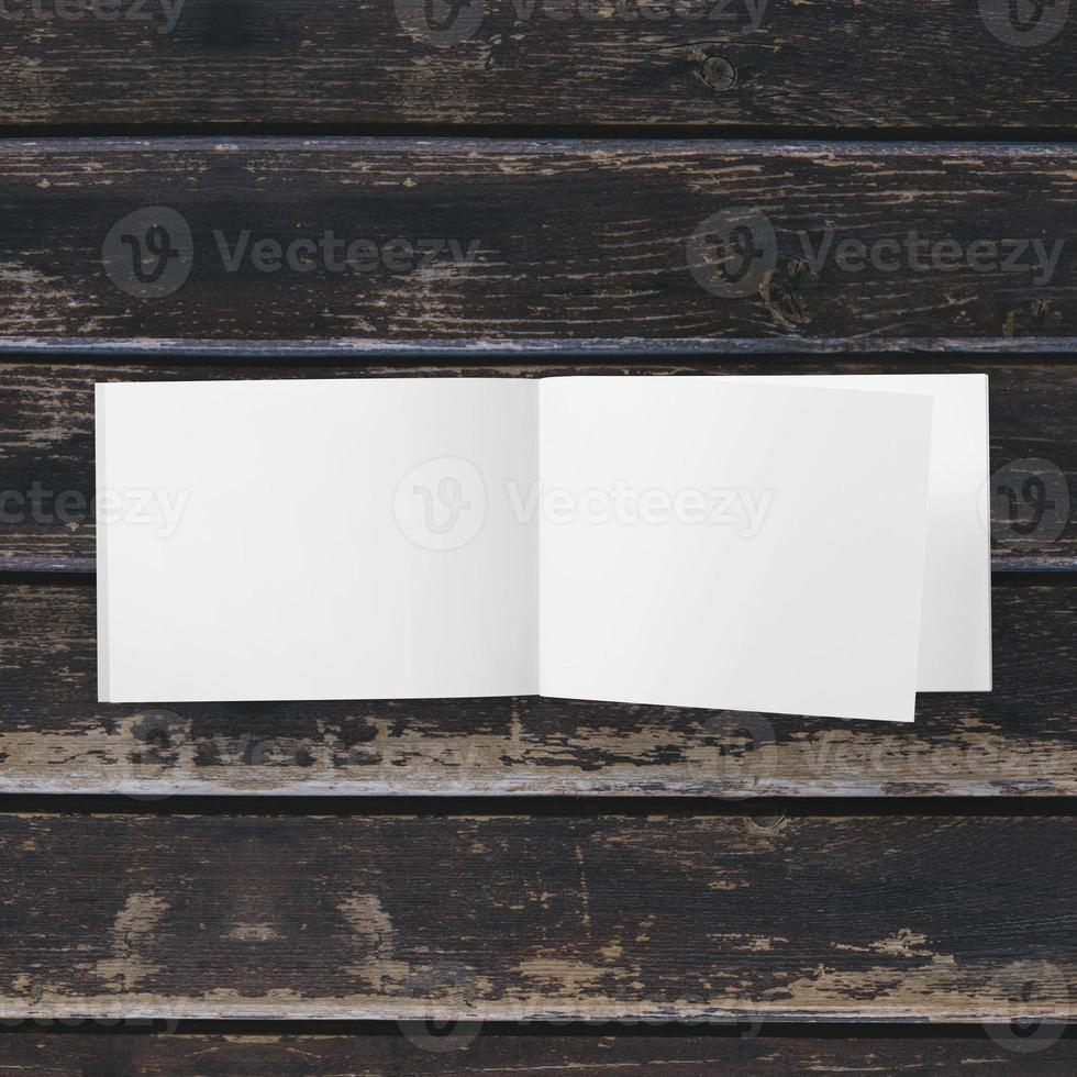 Blank white paper on wooden table photo