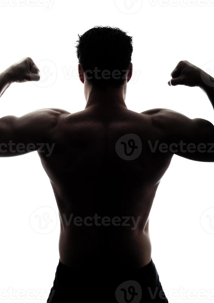 Muscular man's back in silhouette photo