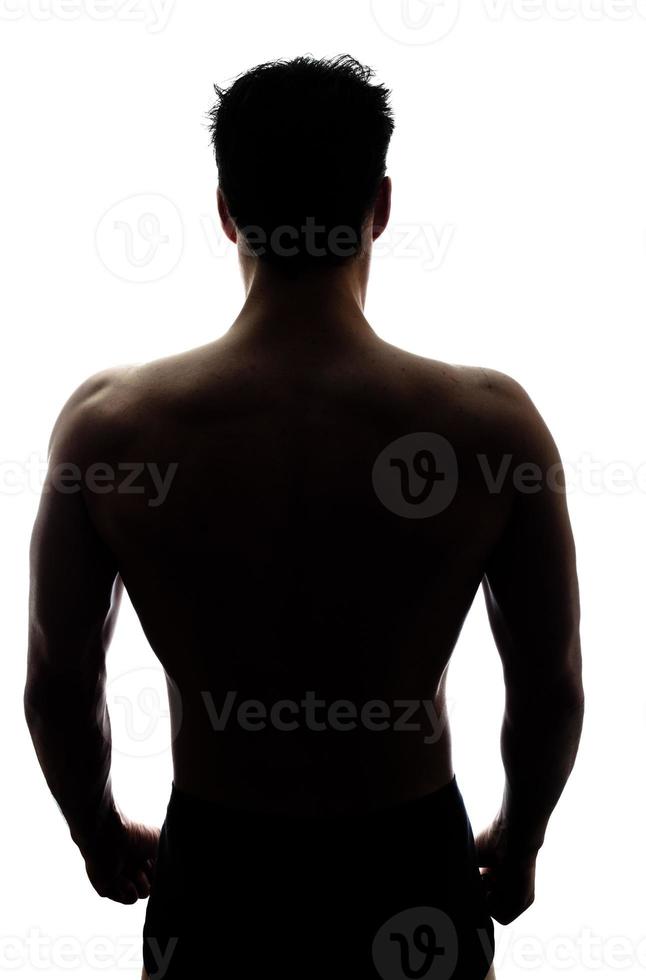 Muscular man's back in silhouette photo