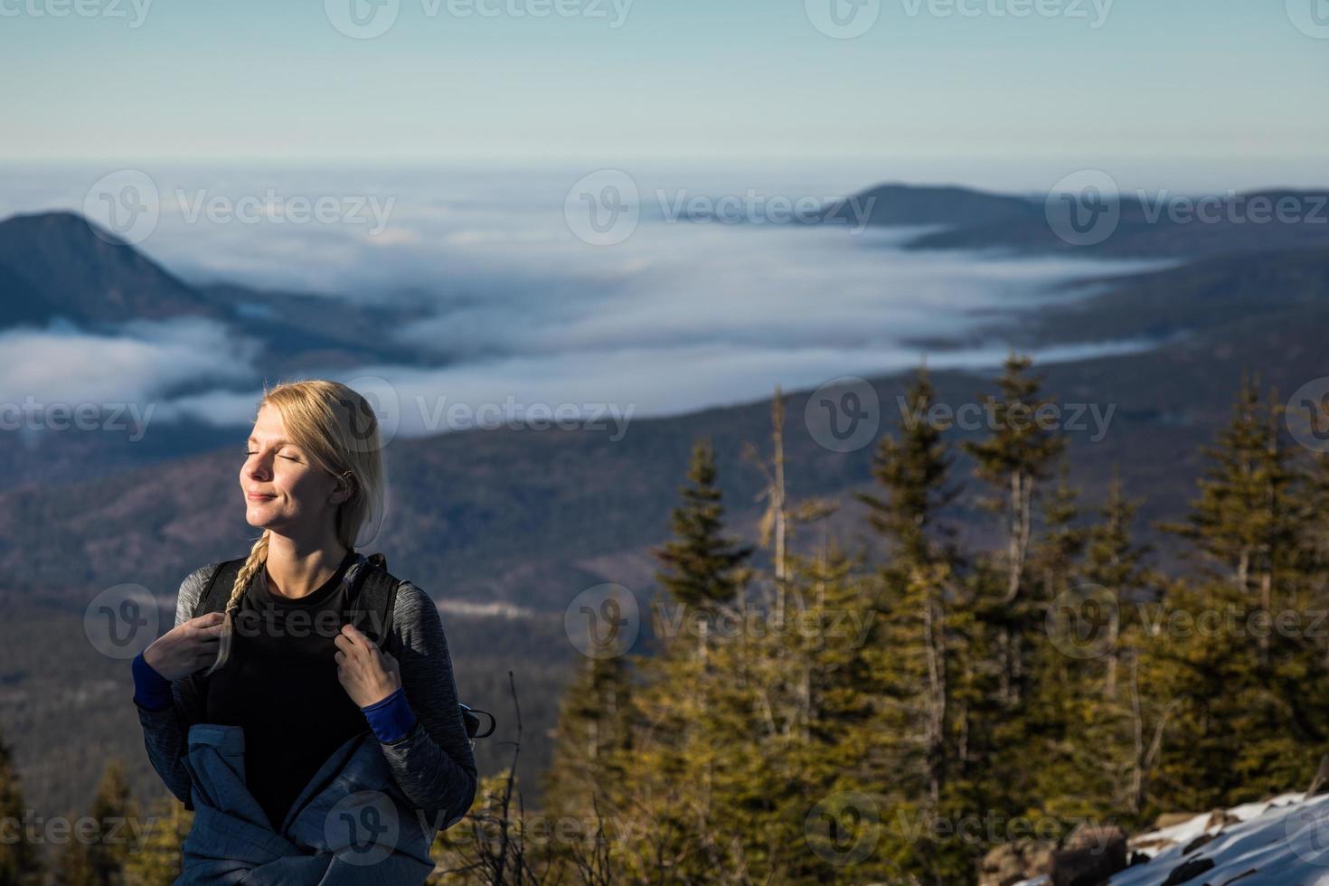 Woman Enjoying the Fresh Air of the Mountains while Hiking to the summit of the Richardson photo