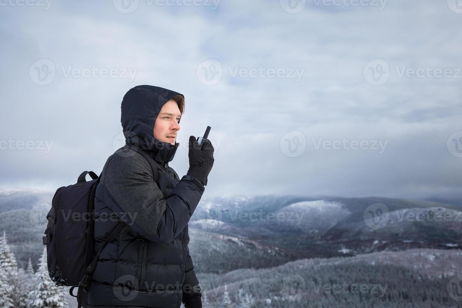 Man on top of mountain in winter photo