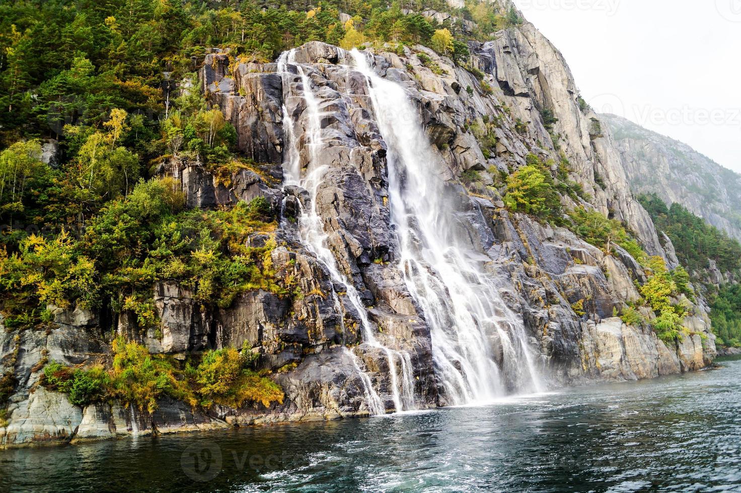 Rock formation in the Lysefjord with the famous Hengjanefossen waterfall photo