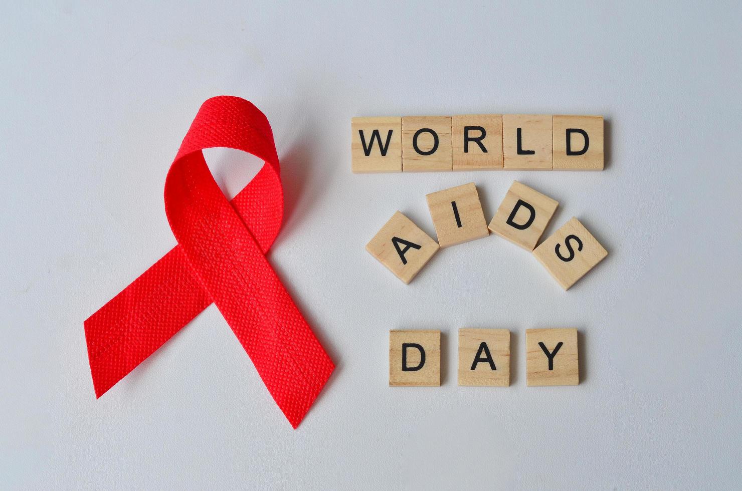 World Aids Day text on wood, isolated at white background photo