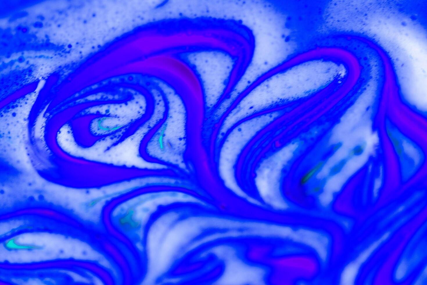 abstract light purple beautiful liquid marble fluid acrylic paint vibrant texture on purple. photo