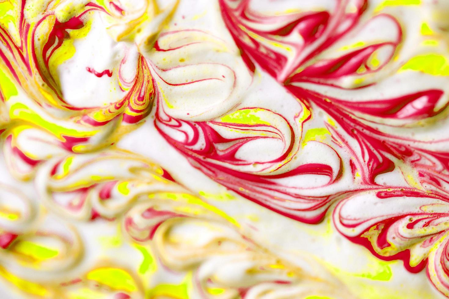 abstract yellow and red beautiful liquid marble fluid acrylic paint vibrant texture on white. photo