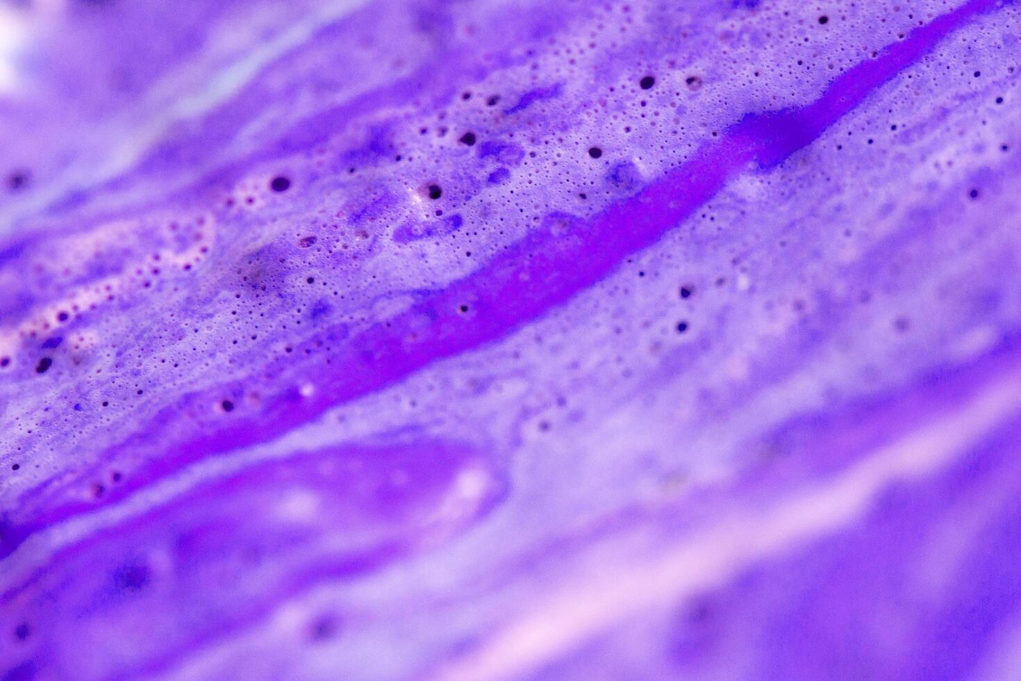 abstract light purple beautiful liquid marble fluid acrylic paint vibrant texture on purple. photo