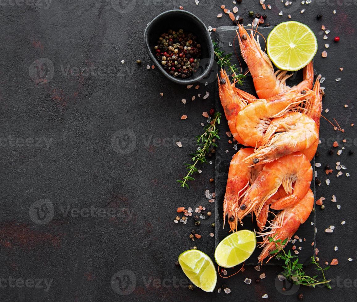 Shrimps or prawns served with lemon photo