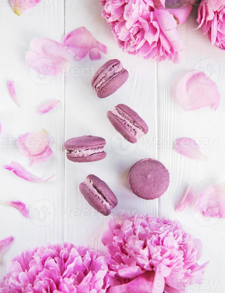 Pink peony flowers with macarons photo