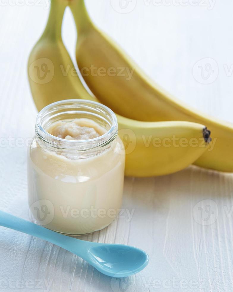 Jar of banana puree,  and bananas photo