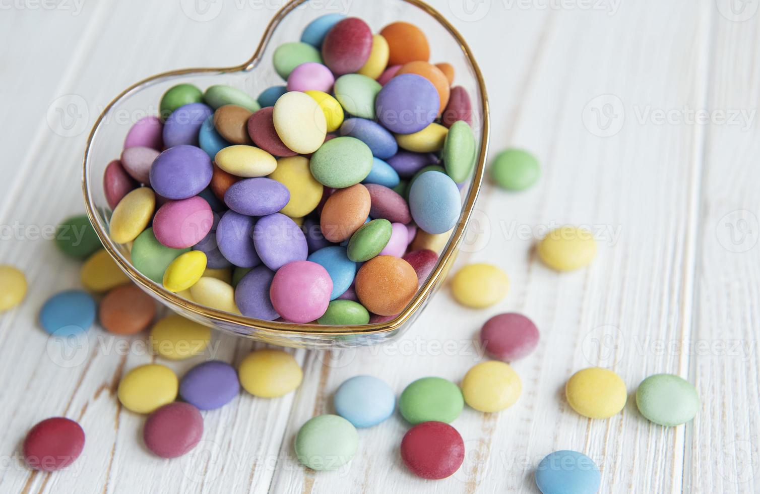 Bowl with multicolored dragee candie photo