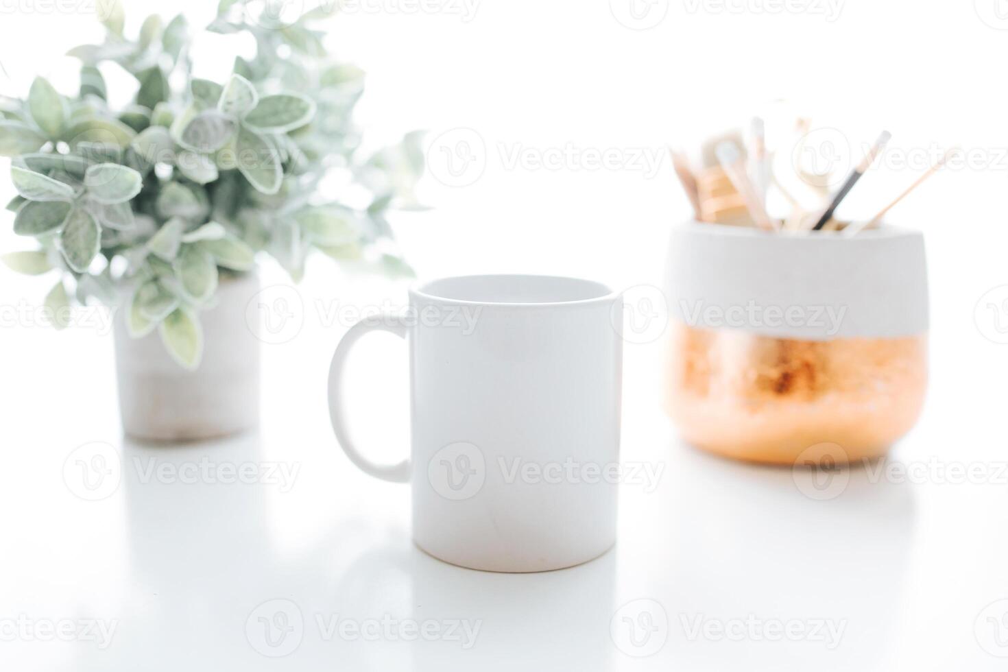 white coffee mug with green leaf for mock-up set isolated glassy tankard design on white photo