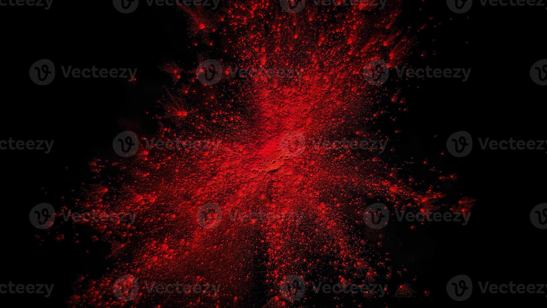 light red colorful powder explosion colored cloud dust explode on black photo