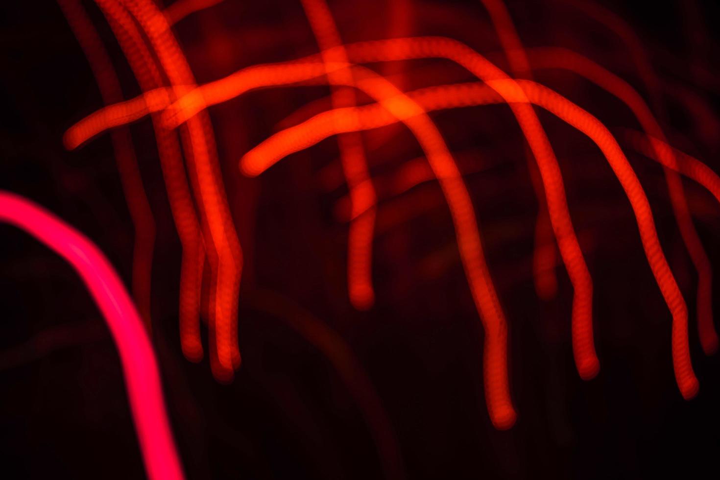 light orange and pink light trail blur abstract lights at motion exposure time swirl trail effect photo