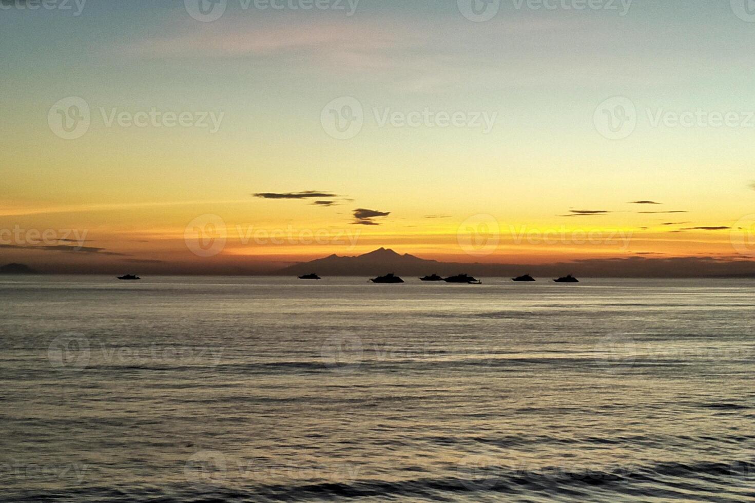 sea backdrop of mountains and evening sky photo