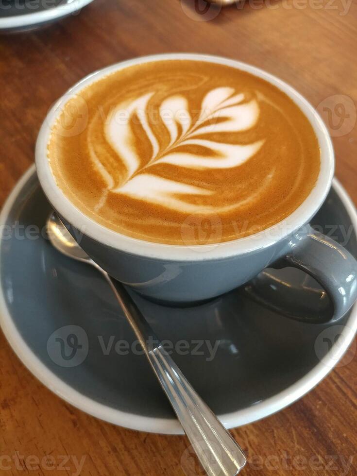 café con leche en forma de árbol en una taza blanca foto