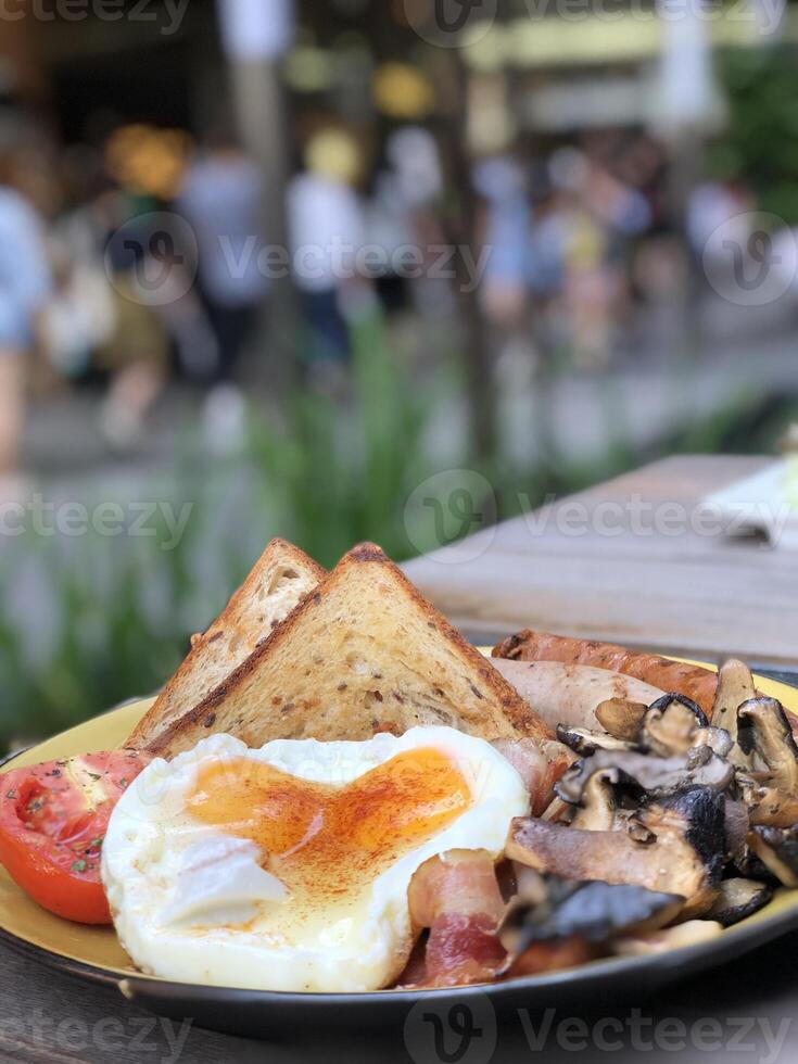 toast with sunny side up egg and salad on a plate photo