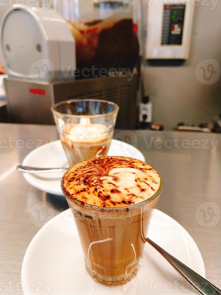 milk coffee with latte and chocolate powder in a glass with motion blur photo