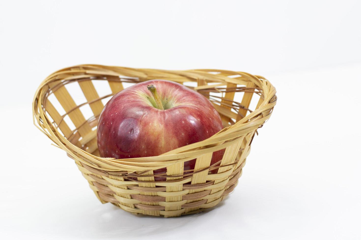 Apples in basket on white table. pan shooting photo