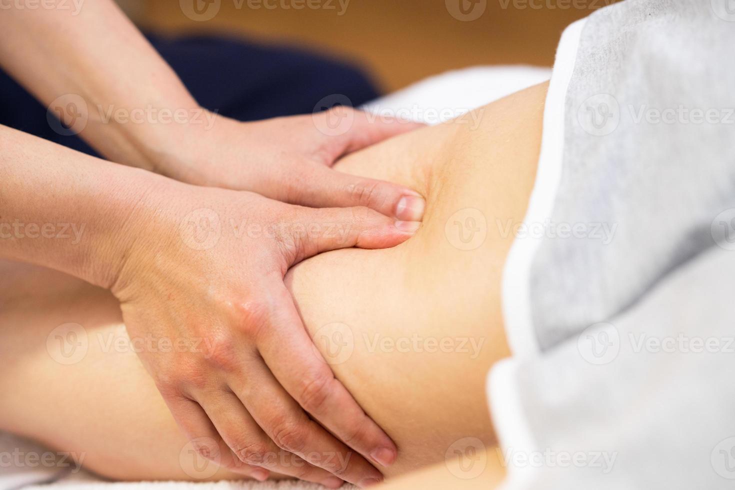 Medical massage at the leg in a physiotherapy center. photo