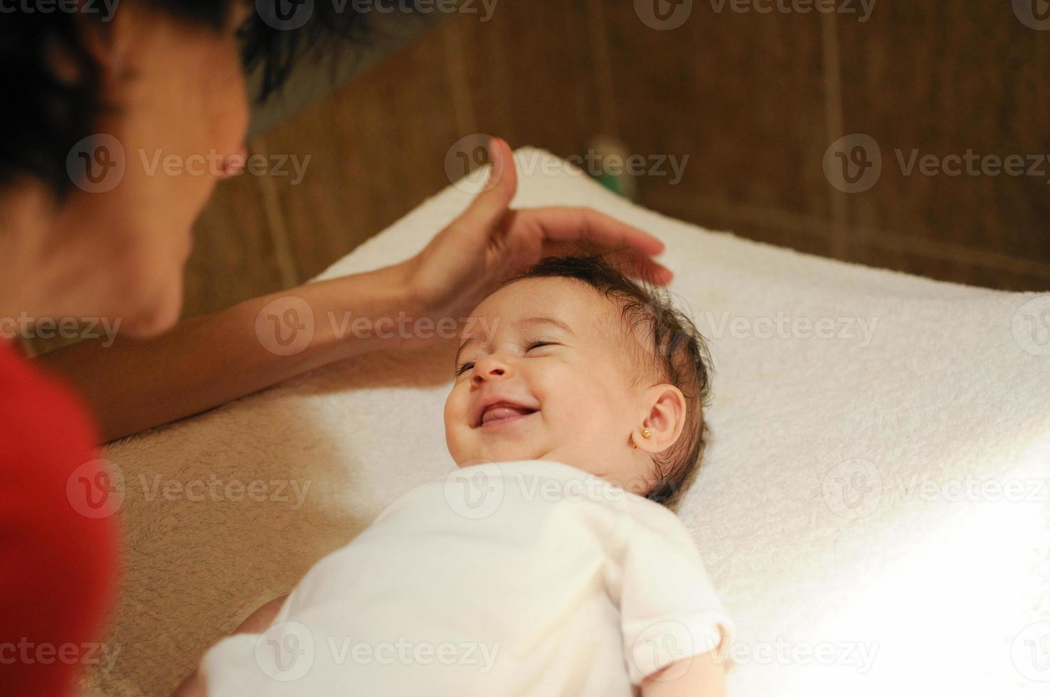 Baby girl two months old smiling to her mother photo