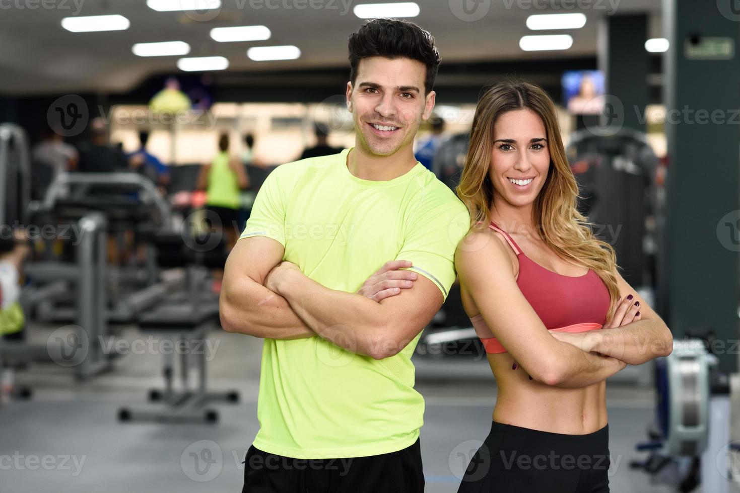 Man and woman personal trainers in the gym. photo