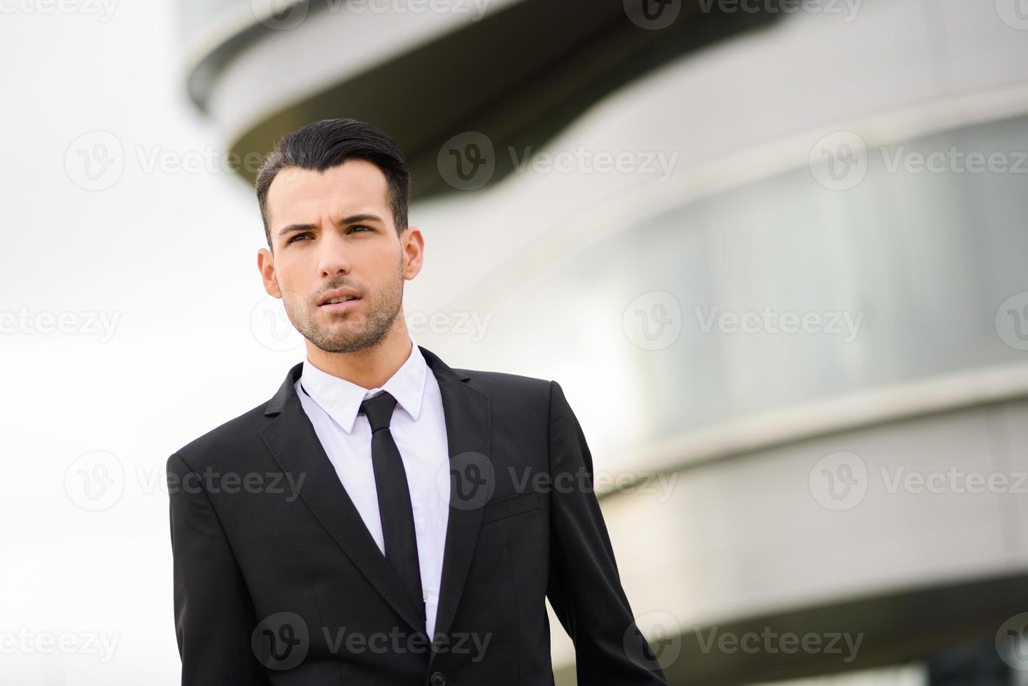 Young businessman near a office building photo