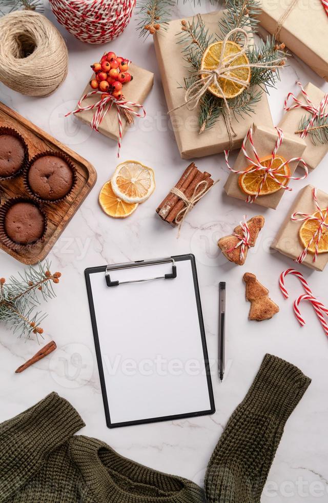 top view writing new year goals, resolution or shopping list on a blank paper. Mock up design photo