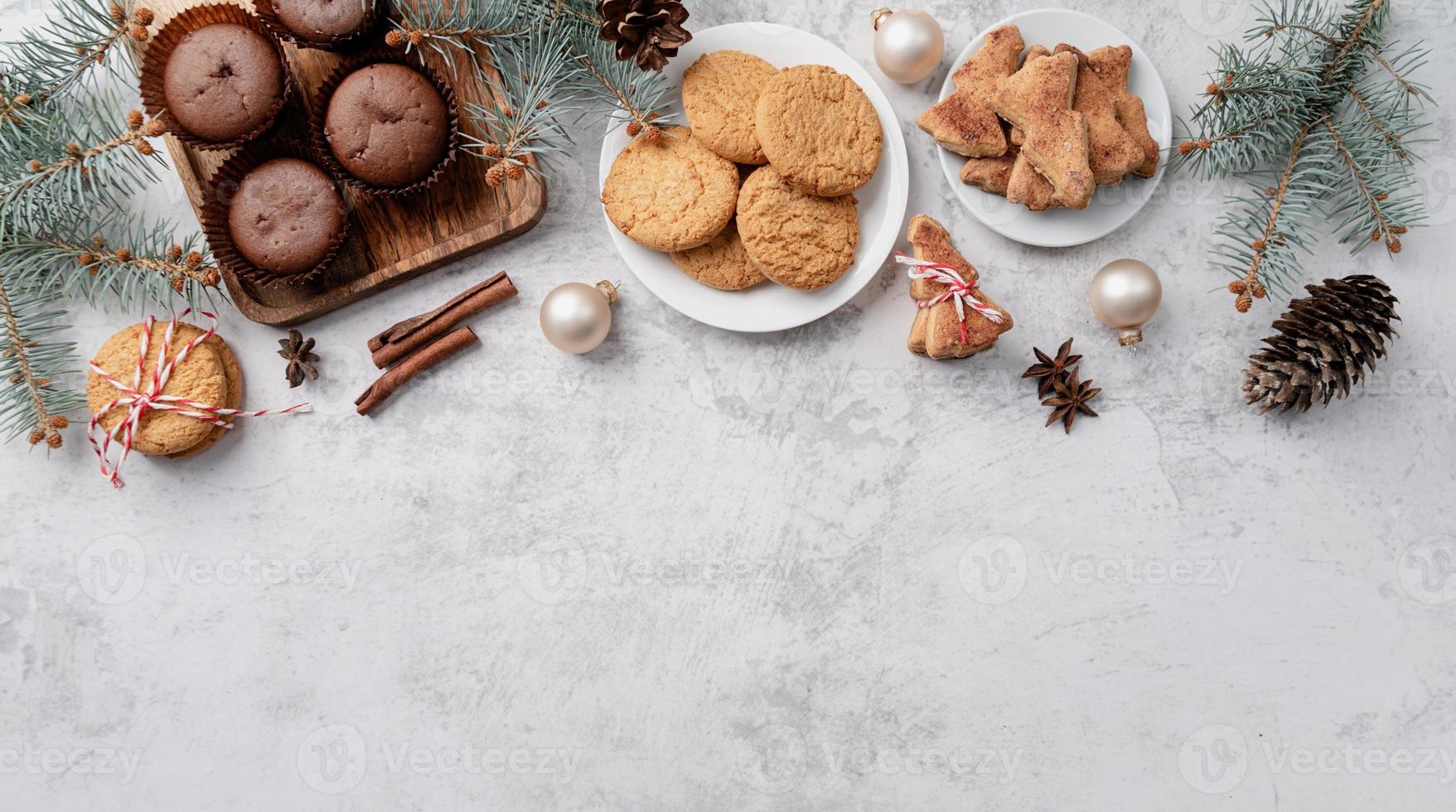 top view christmas cookies, muffins and gingerbread flay lay with copy space photo