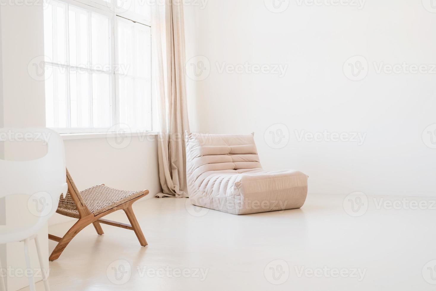 diseño interior minimalista, luminoso y aireado, silla, alfombra y almohadas blancas y beige foto