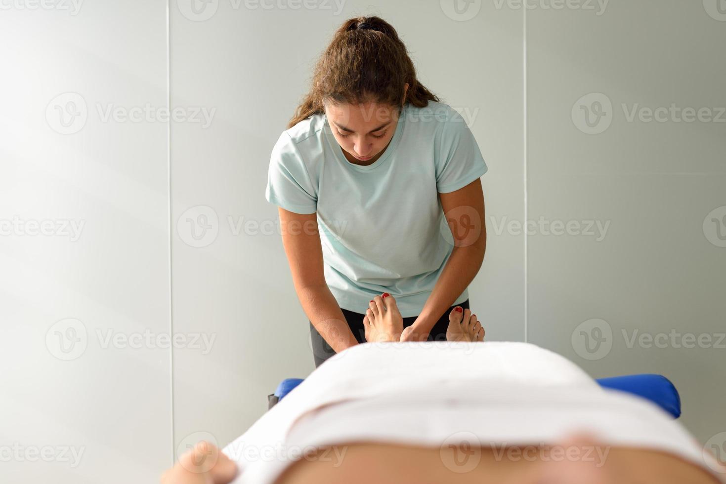 Medical massage at the foot in a physiotherapy center. photo