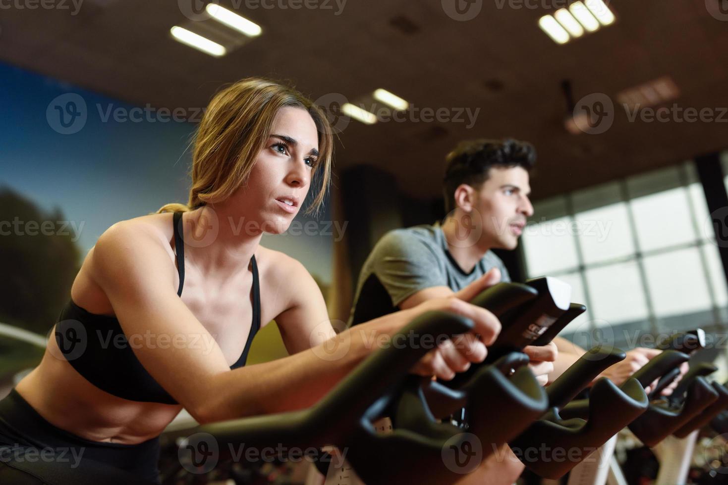 Couple in a spinning class wearing sportswear. photo