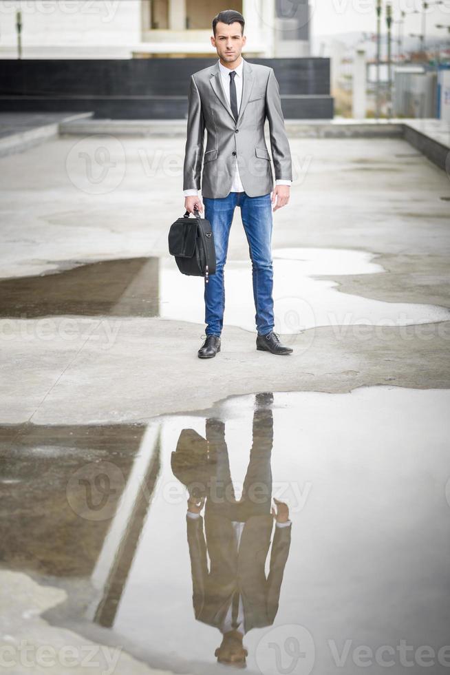 Young businessman near a office building photo