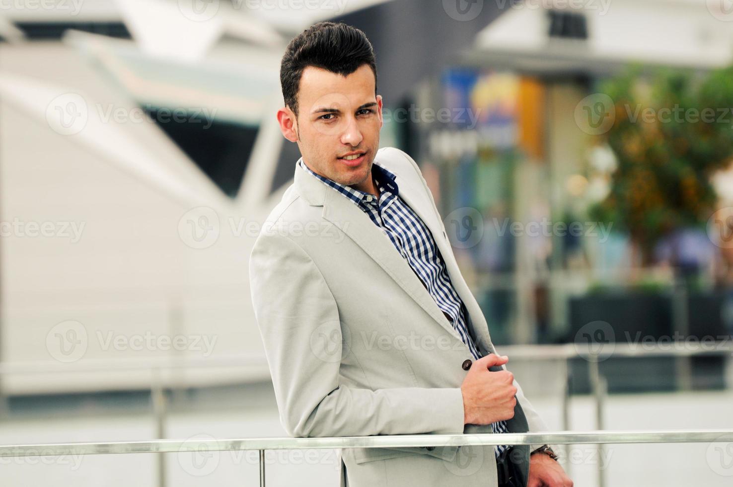 Handsome man wearing jacket and shirt in urban background photo