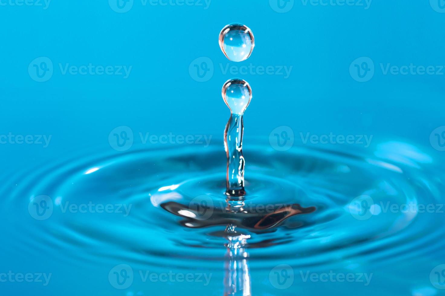 transparent water drop splash realistic and blue water colored on white. photo