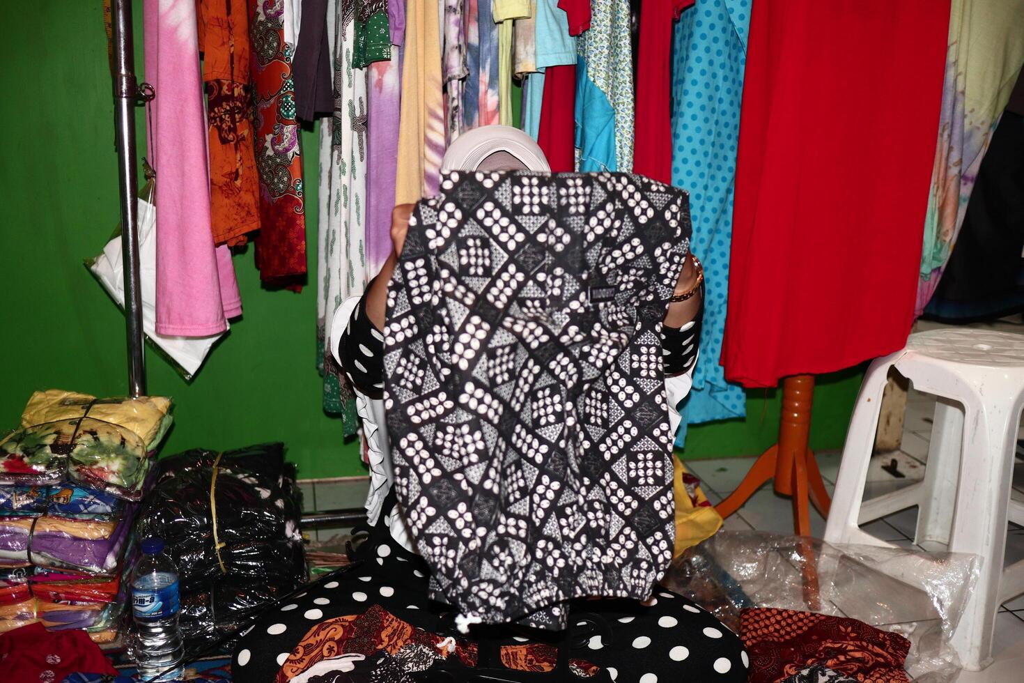 Batik traders when arranging their selling items in the shop at Pekalongan Central Java Indonesia photo