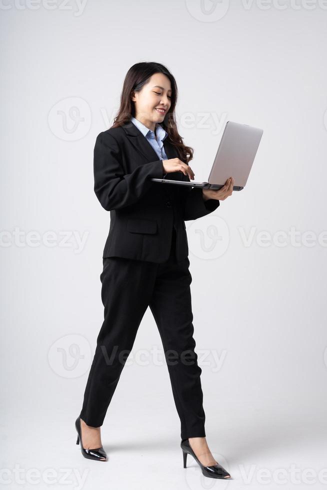 full body image of beautiful young asian businesswoman, isolated on white background photo