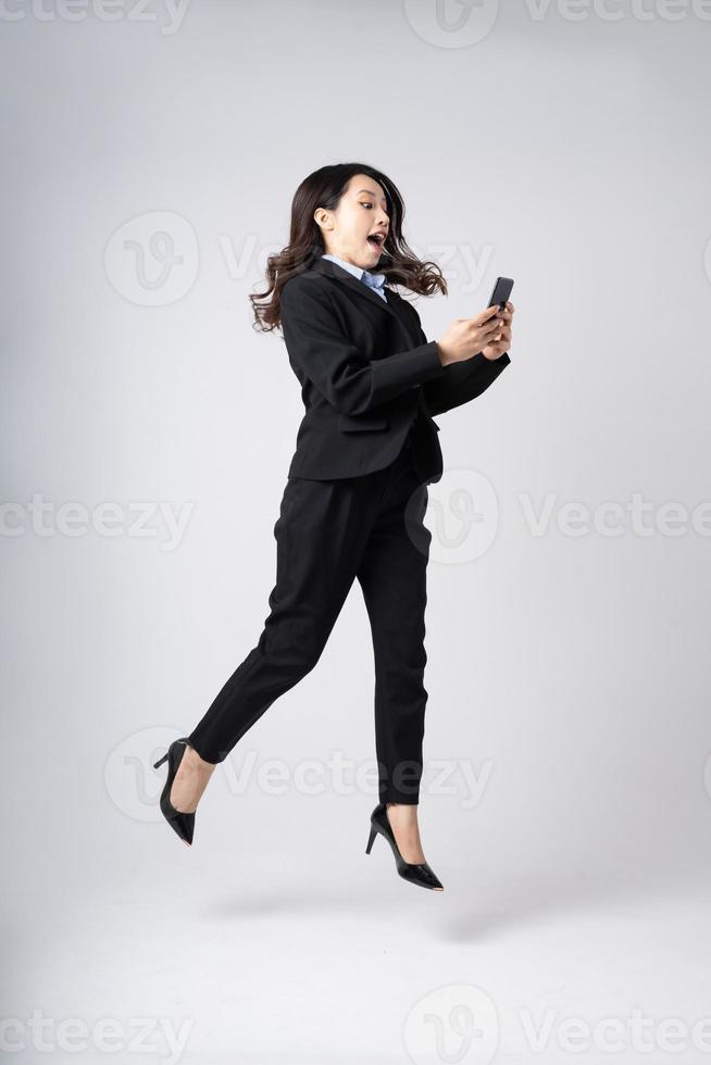 full body image of beautiful young asian businesswoman, isolated on white background photo