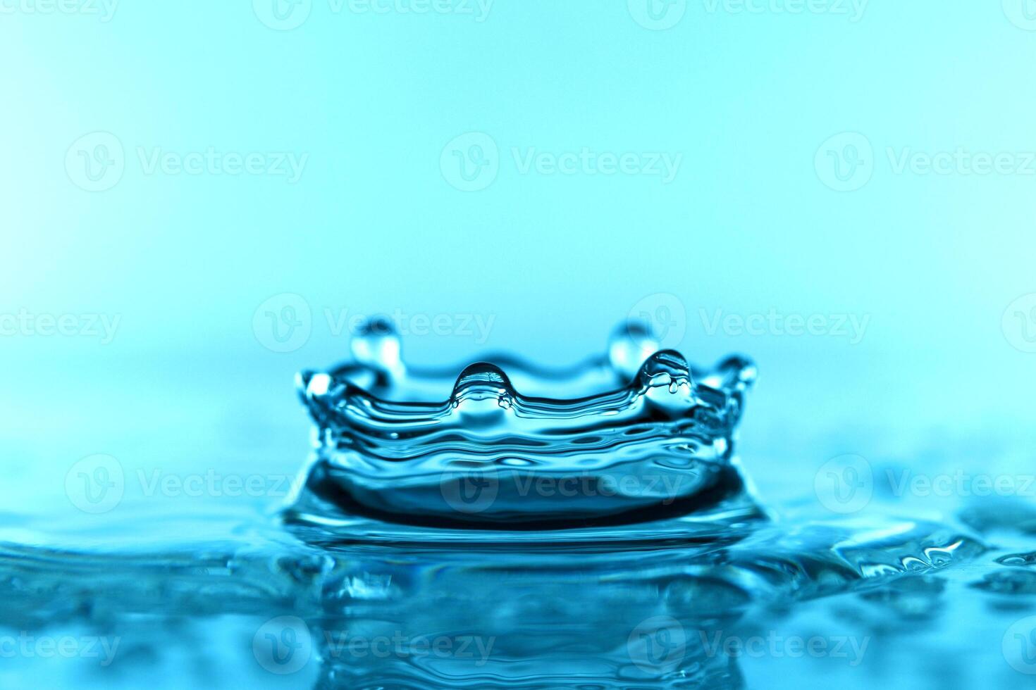 light blue transparent water wave surface with splash bubble on water. photo