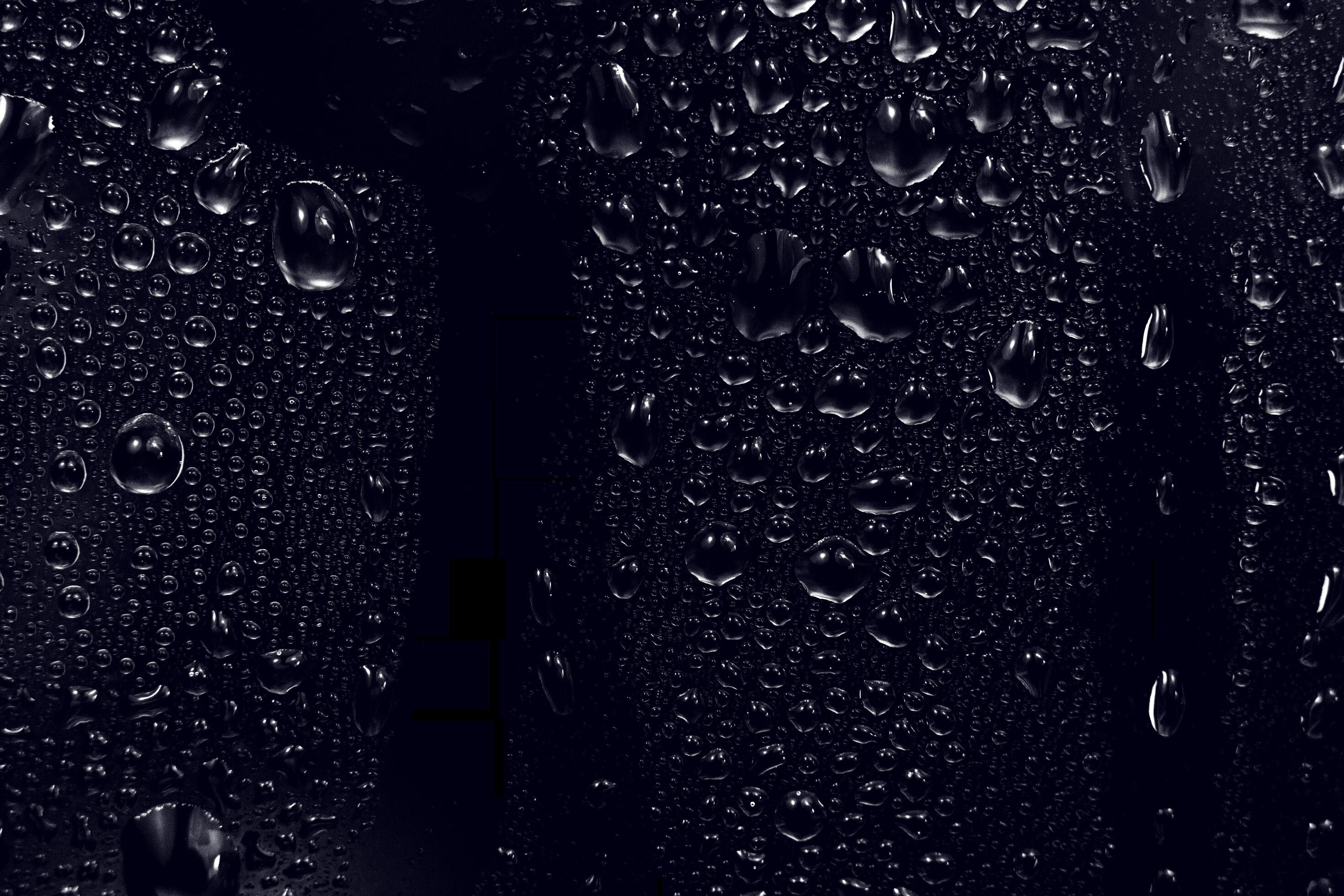water drops on black background. abstract dew water droplets on a
