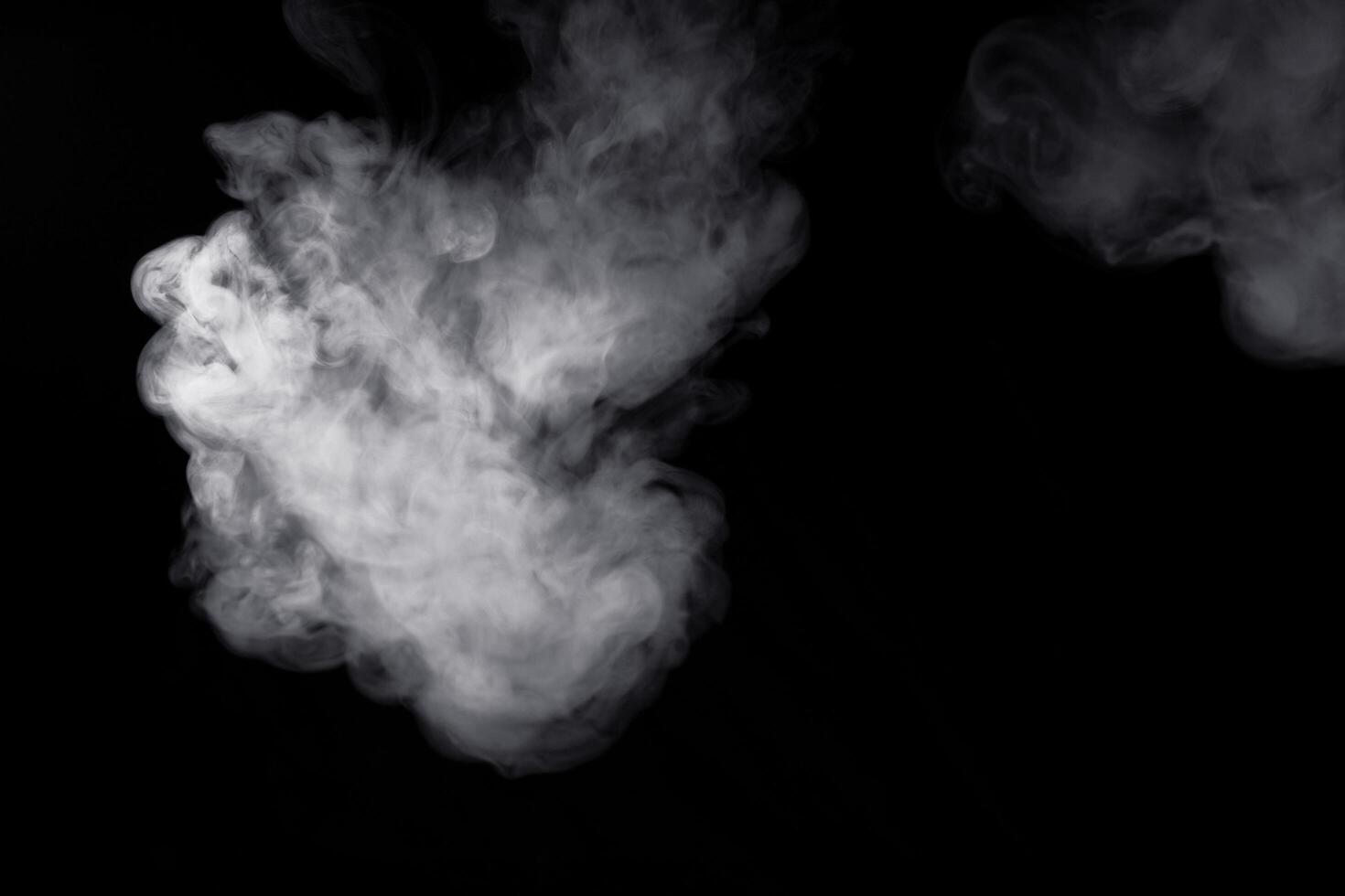 white smoke on black background for overlay effect. a realistic smoke effect for creating an intense nuance in a photo