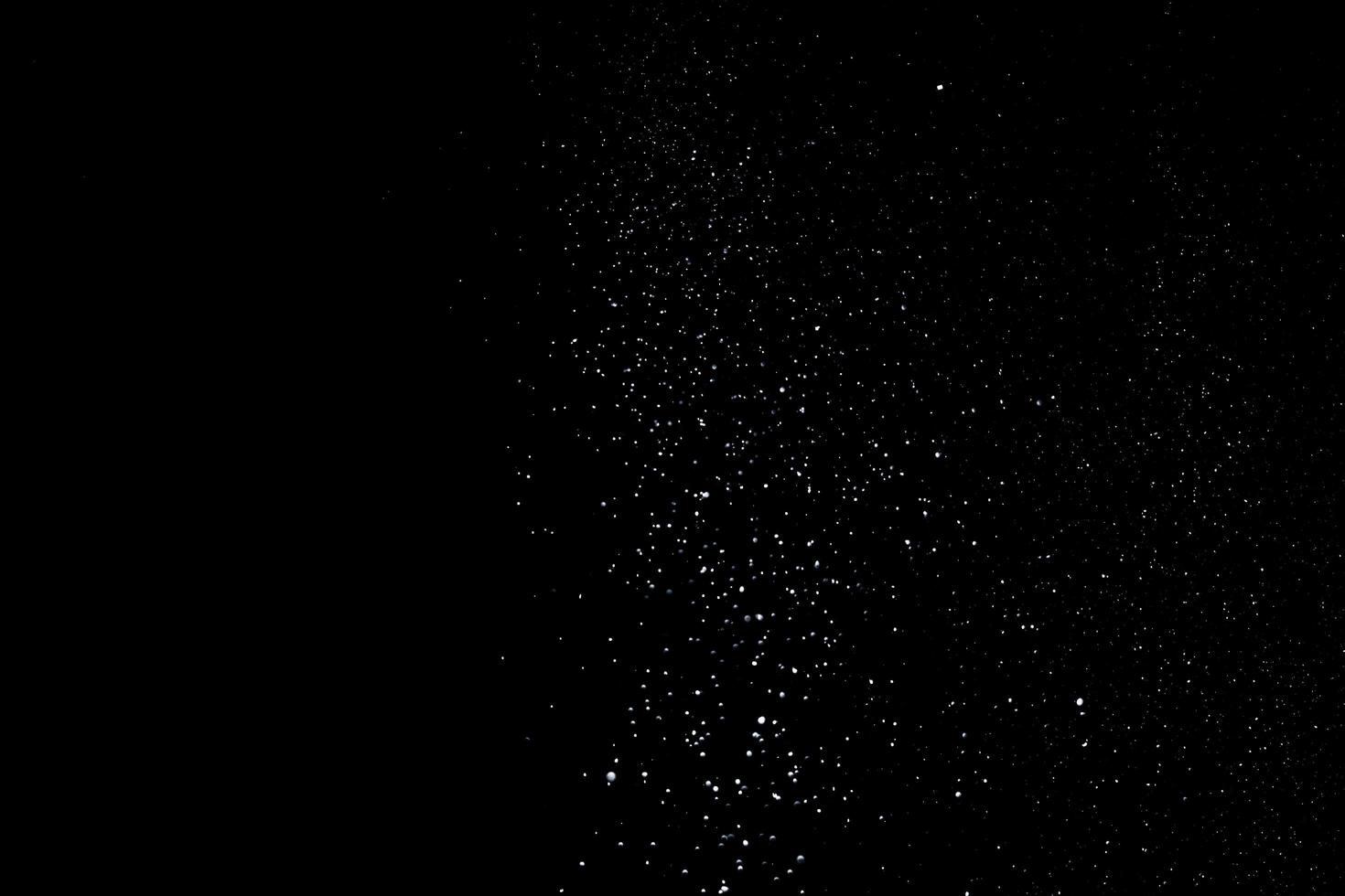 the white particles on black background representing a snowfall. Snow overlay footage for giving a freezing or winter effect to the video presentation. photo