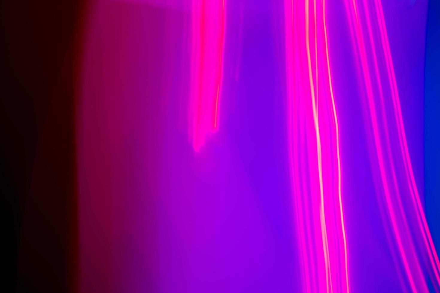 neon light motion on black. colorful abstract light background. shining light for decorating design as background and overlay to beautify a creative project. photo