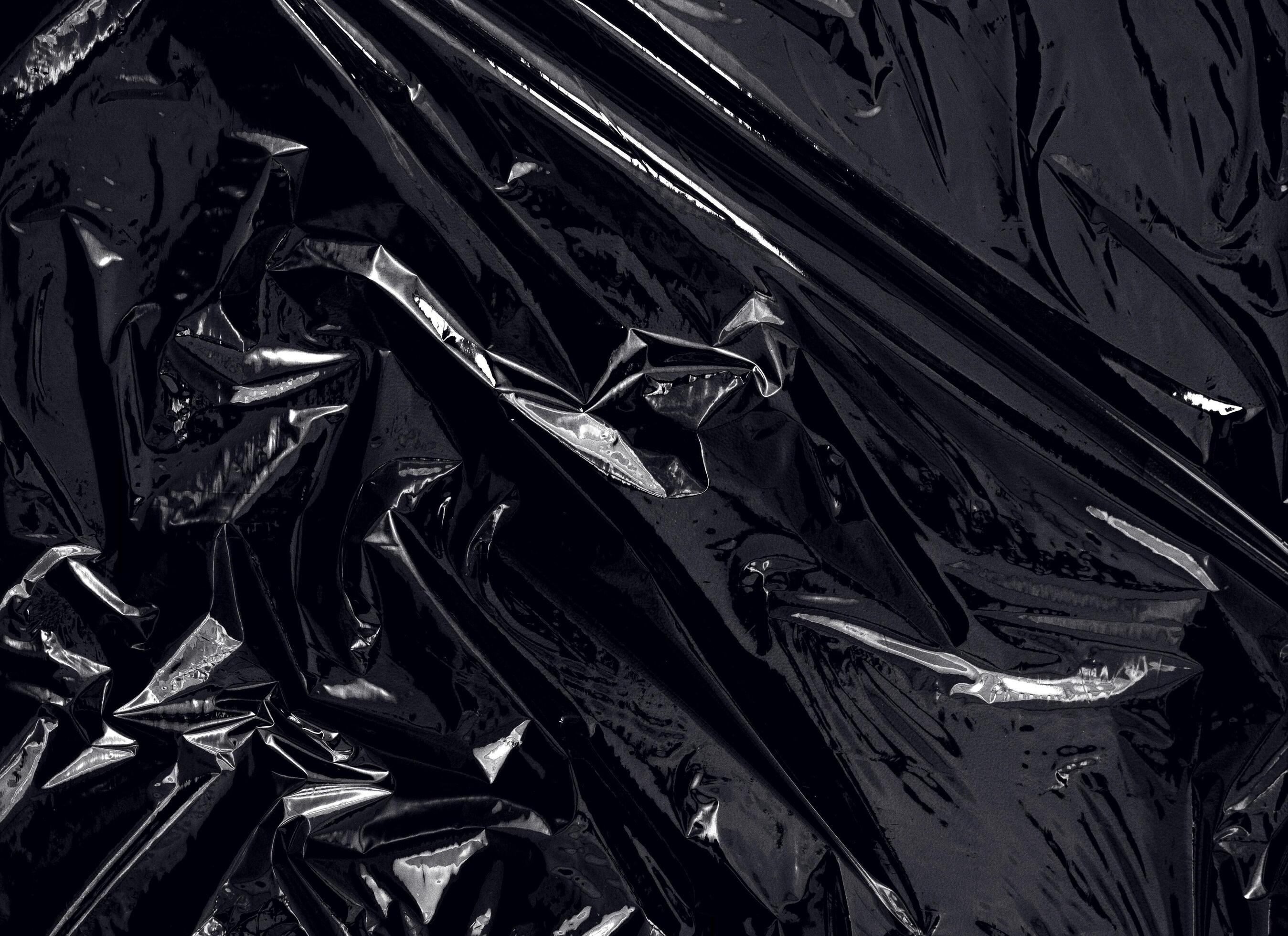 a transparent plastic wrap on black background. realistic plastic wrap