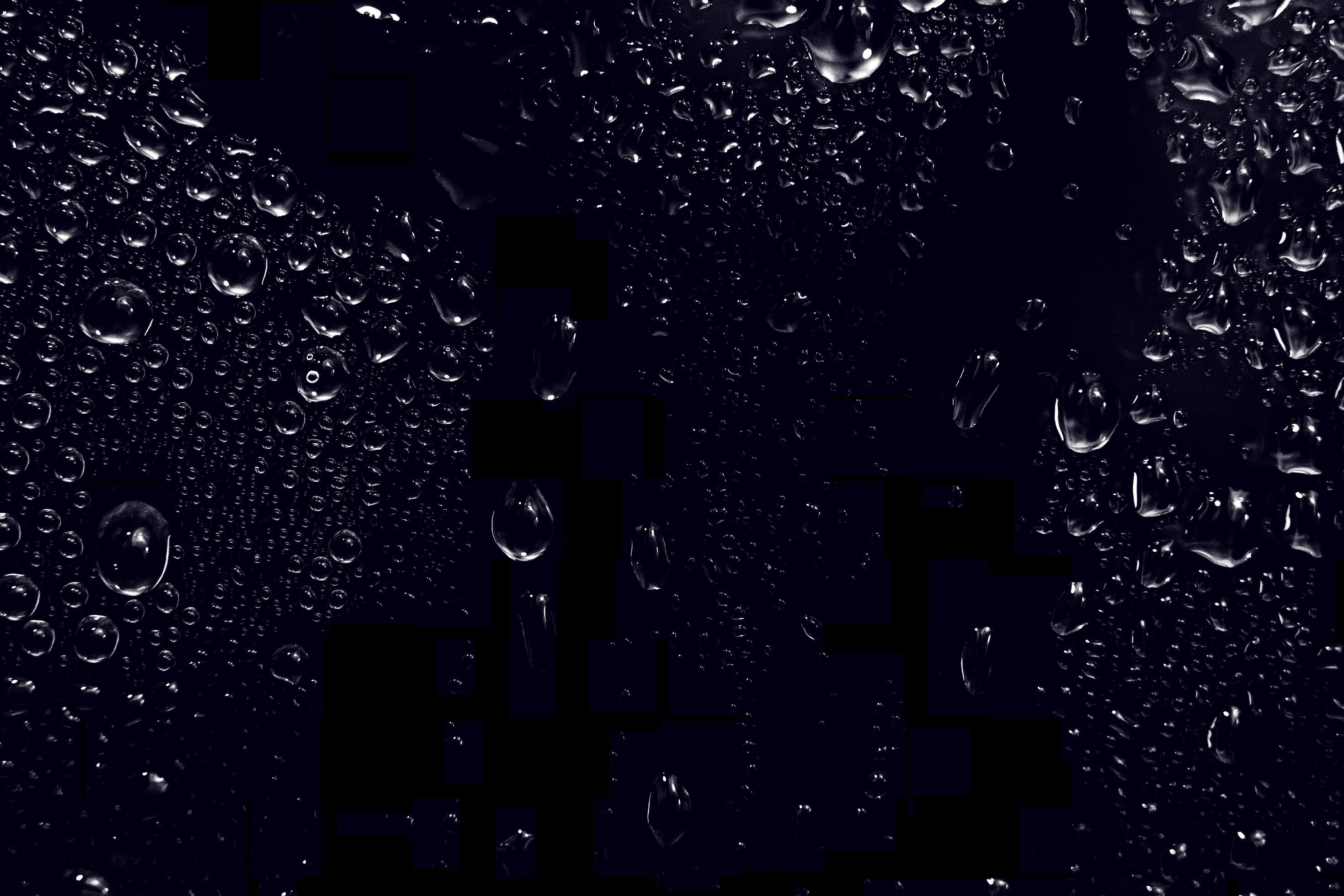 water drops on black background. abstract dew water droplets on a
