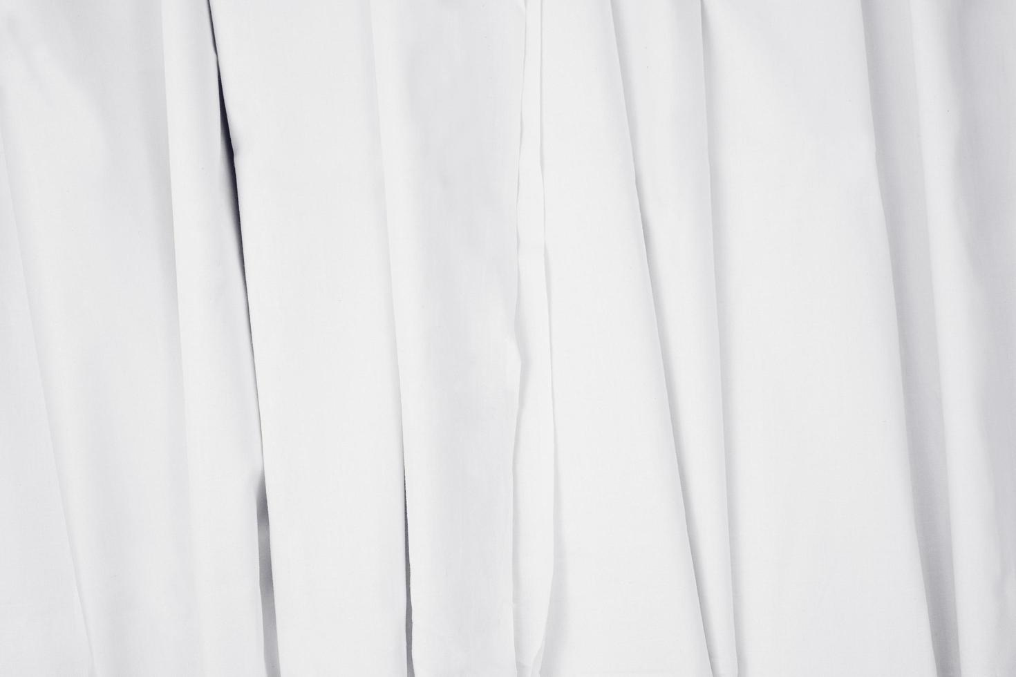 wavy folded white fabrics. well designed white curtain concept. textile texture mockup for creative design preview. photo