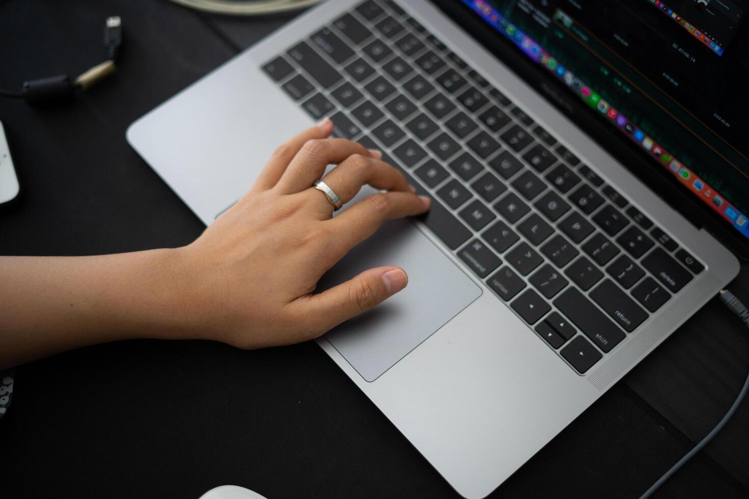 hand on top of the keyboard. working from anywhere using a laptop. photo