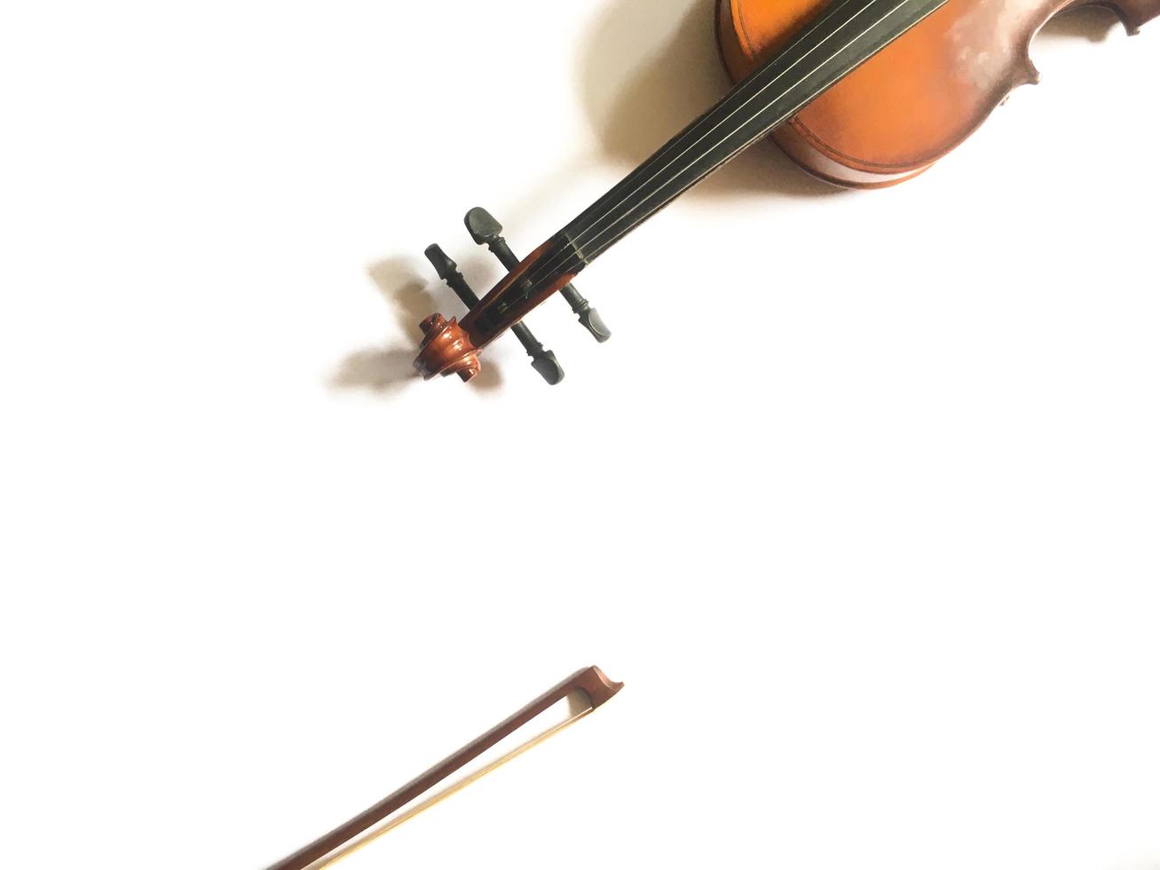 a violin and bow isolated on white with copy space. a classic music instrumental played with swiped that is usually performed in classical music shows. photo