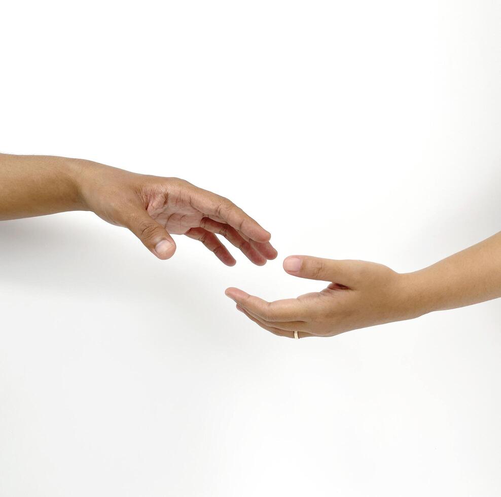 two hands of male and female reaching out and almost pulling. for couple means trust, caring, and togetherness in relationship. isolated on white background. photo