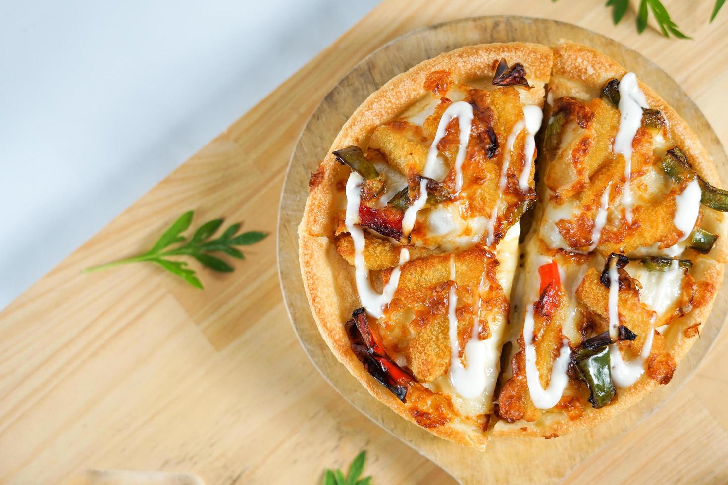 Italian pizza with some tasty topping on it. a studio shot of a delicious food served on the wooden peel with copy space. photo